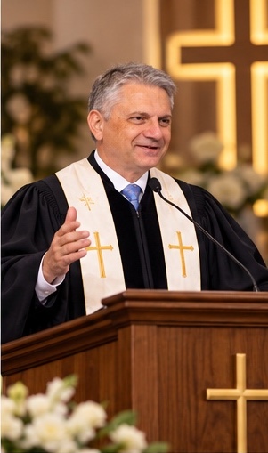 Rev. Gian Luca Bignardi preaching from the Bible